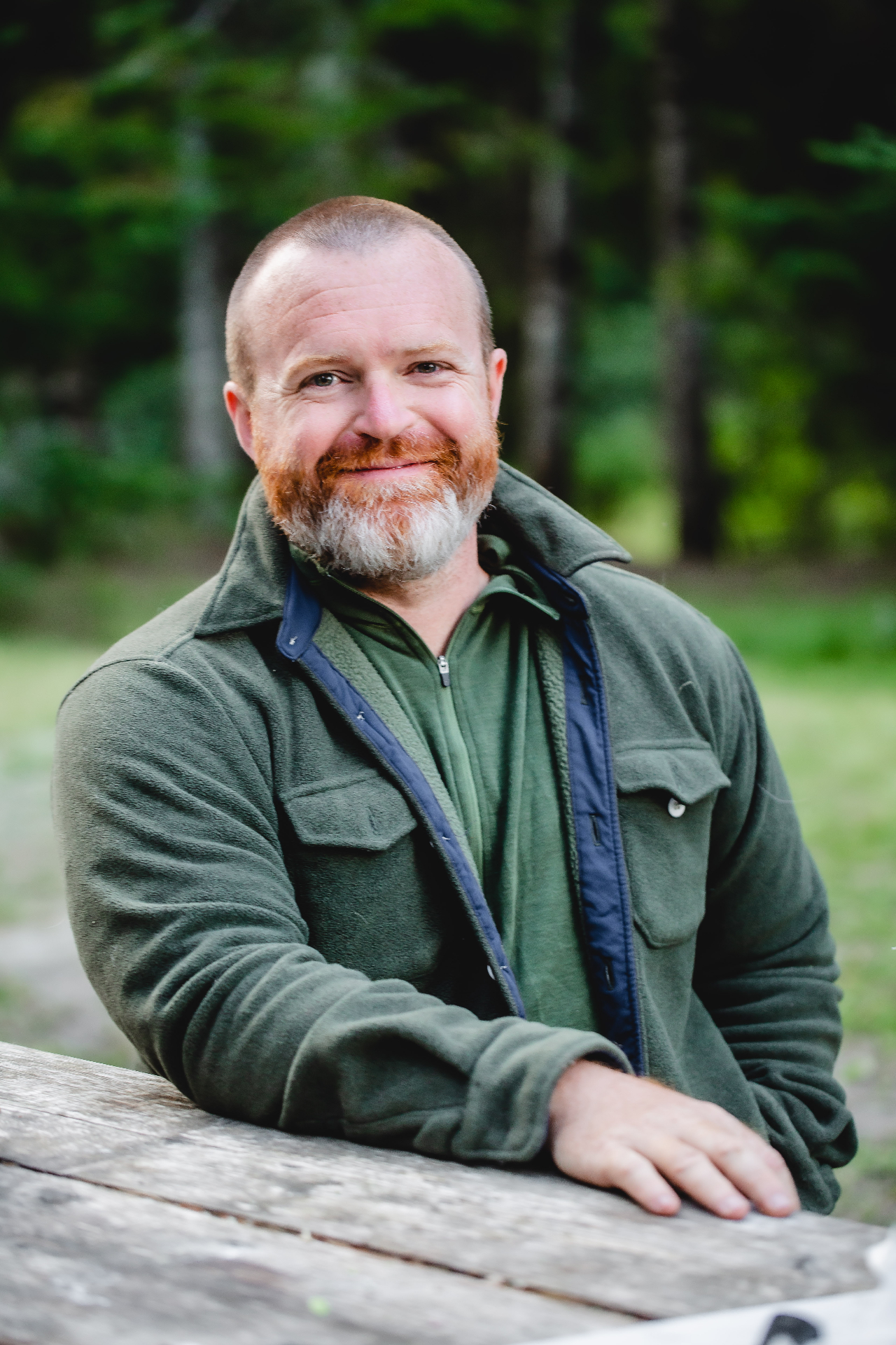 Dan Doty standing outdoors in a forest setting